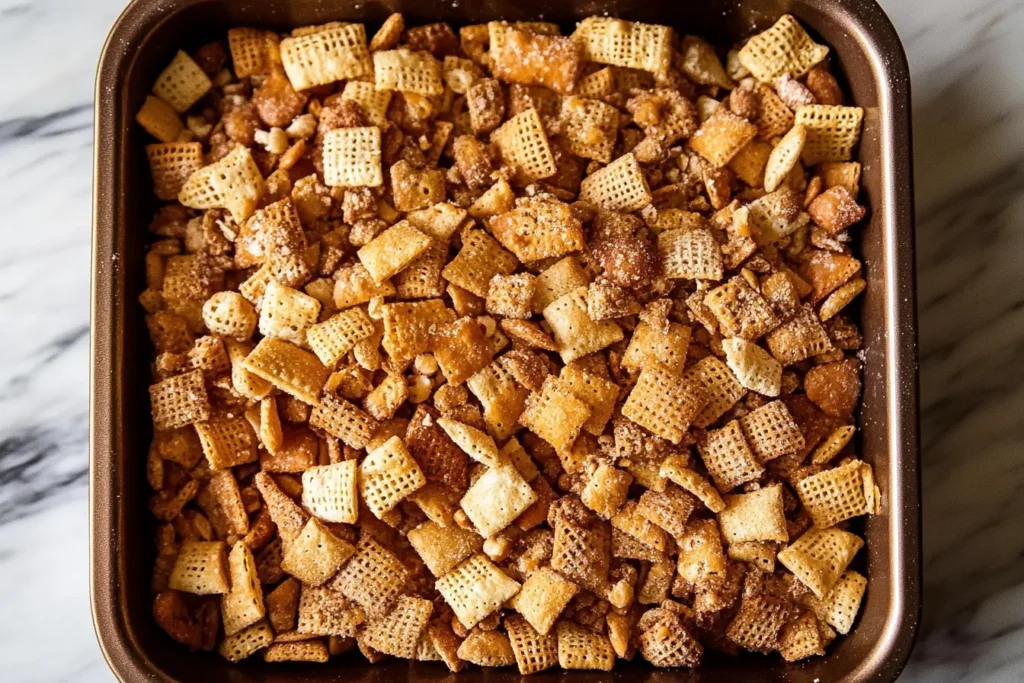 Step-by-Step Instructions for Making Chex Mix in a Roasting Pan Step-by-step process of making Chex Mix in a roasting pan, showing ingredients being mixed and seasoned.