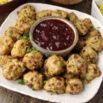 Table with Thanksgiving appetizers including cheese platter, dips, and mini tarts