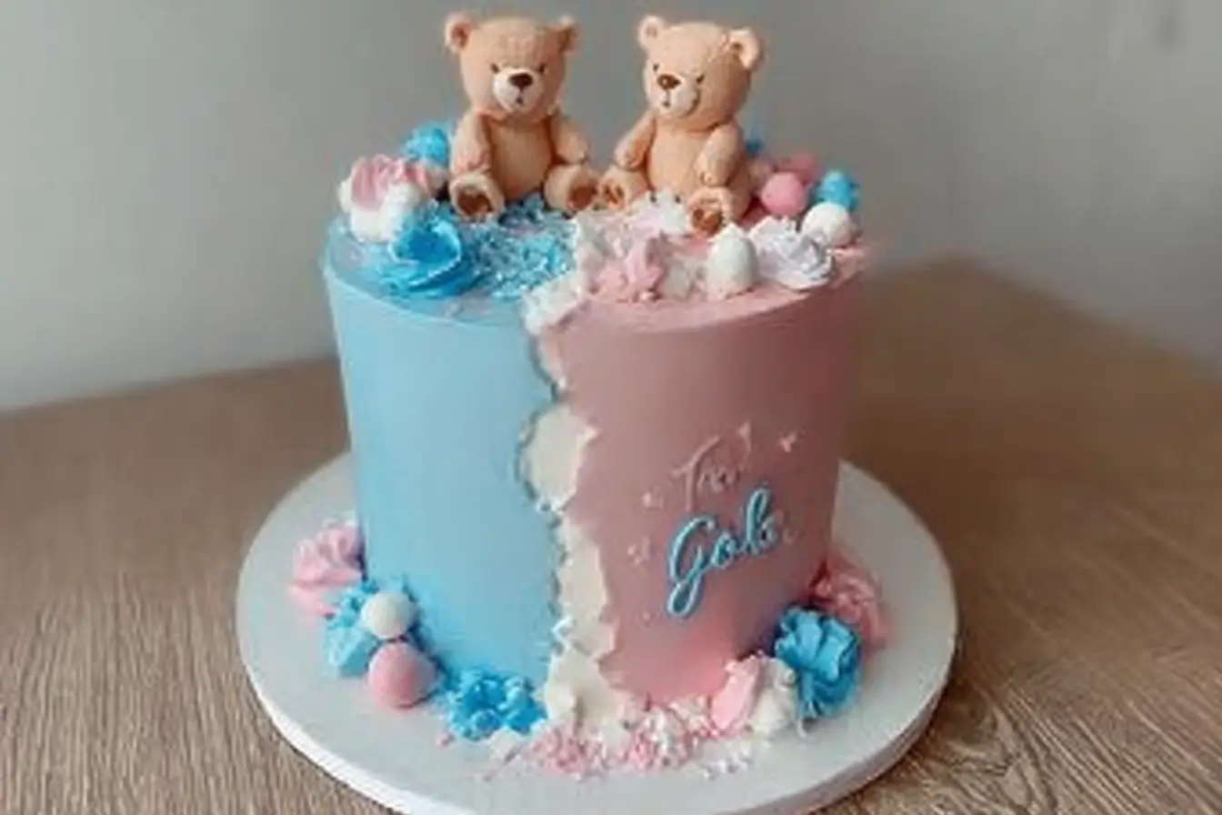 Beautiful Gender Reveal Cake with pink and blue decorations and hidden color filling