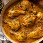Smothered chicken in creamy gravy served with mashed potatoes and herbs