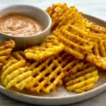 Crispy homemade Chick-fil-A waffle fries served with dipping sauce