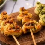 Golden Pesto Puff Pastry Christmas Trees topped with parmesan and fresh herbs.